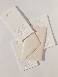 four white envelopes are laying on top of each other, with the same letter printed on them