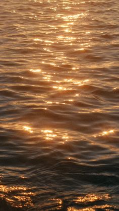 the sun shines brightly on the water as it reflects off the surface of the ocean