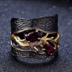 New 18kt Black Gold & 18k Yellow Gold Filled Genuine Natural Rhodolite Garnet Flower Designer Ring, Wedding Band, Engagement Ring, Promise Ring, Anniversary Ring, Statement Ring, January Birthstone Ring. Size 7. Absolutely Gorgeous, Very Shiny Lustrous Beautifully Designed Unique Eye Catching Statement Ring! Great January Birthstone Birthday Gift Idea! **Also Comes In A Luxury Ring Box Perfect For Gift Giving Or Proposing!** * High Quality! * Lead & Nickel Free! * Hypoallergenic! * Real 18kt Yel Garnet Ring Vintage, Rhodolite Garnet Ring, Wide Silver Ring, Red Garnet Ring, Garnet Crystal, Retro Ring, Vintage Style Rings, Gothic Rings, Garnet Ring