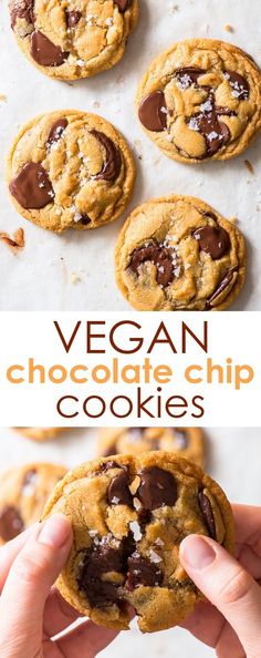 vegan chocolate chip cookies on a baking sheet and in the background, there is a hand holding one