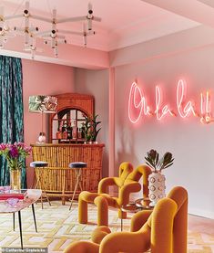 a living room filled with furniture and neon lights