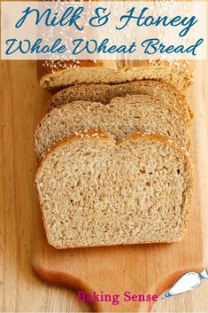 a loaf of whole wheat bread on top of a wooden cutting board with the words milk and honey whole wheat bread