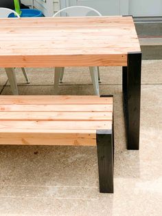 two wooden benches sitting next to each other on top of a tile floored floor