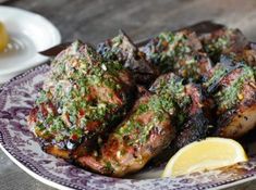 grilled meat with herbs and lemon on a plate