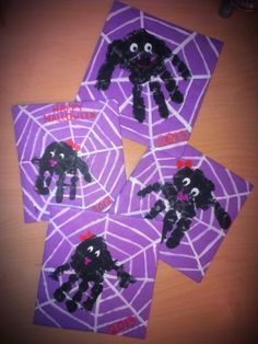 four purple cards with black and white spider webs on them, each decorated to look like a dog