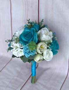 a bridal bouquet with blue and white flowers