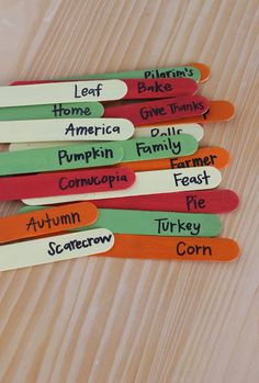 five wooden spoons with names on them sitting on a table next to each other