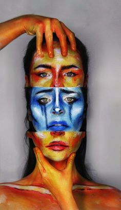 a woman's face painted with multiple colors