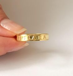 PERSONALIZED NAME and WORD RING This minimalist and Dainty custom Name Ring, Minimalist Name Ring can be worn every day. Personalize this ring with your name, Roman numerals, coordinates and words. Simple and elegant design makes a perfect gift for all special occasions! FEATURES Material: Crafted in 18K Gold plated .925 Sterling Silver and 14K solid Gold Color: Silver, Gold, Rose Gold The item will come with a gift box. The premium hand formed ring is 4mm wide and 1mm thick All our jewelry is % Luxury Statement Engraved Ring Gift, Custom Name Initial Ring For Engagement, Custom Name Ring, Ring With Name, Roman Numeral Ring, Mantra Ring, Couple Ring Design, Word Ring, Dainty Initial Necklace