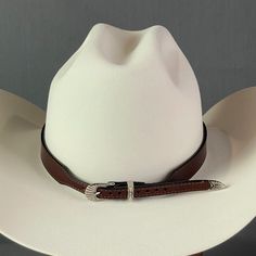 The Classic Leather Cowboy Hat band is just that, Classic leather with an engraved silver buckle. 3/4" tall light black leather with silver engraved buckle for size adjustment 27-3/4" total length with 10 holes for adjusting ranging from a 22-1/2" length to a 25-1/2" length Available in Black and Brown Cowboy Hat Band, Cowboy Hat Bands, Leather Cowboy Hats, Silver Engraving, Light Black, Hat Band, Cowboy Hat, Classic Leather, Cowboy Hats