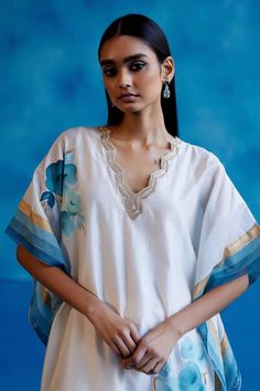 Ivory and blue silk chanderi kaftan featuring floral hand-paint and zari embroidery details on the neckline and hem. Paired with a matching embroidered silk chanderi pant and slip. - Aza Fashions White Silk Embroidered Kaftan, Summer Designer Wear Kaftan With Floral Embroidery, White Embroidered Silk Kaftan, Summer Embroidered Neckline Straight Kurta Kaftan, Summer Kaftan With Embroidered Neckline, Summer Designer Floral Embroidered Kaftan, Bohemian Chanderi Kurta With Embroidered Neckline, Designer Bohemian White Kaftan, Bohemian White Designer Kaftan