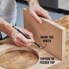 a man is making a piece of wood with the words mark the width on it