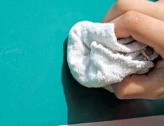 a person wiping their hands with a towel