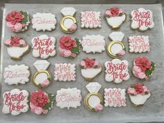 some decorated cookies are on a tray with pink and white frosted icings