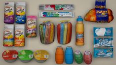 an assortment of snacks and condiments laid out on a white surface next to each other