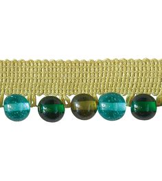 a line of green and black glass beads on a yellow ribbon with gold trimming