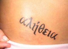 a woman's lower back tattoo with the word aipeea written on it