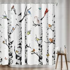 the shower curtain is decorated with birds and birch trees