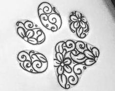 four hearts with swirls on them are drawn in black and white ink, sitting on top of a piece of paper