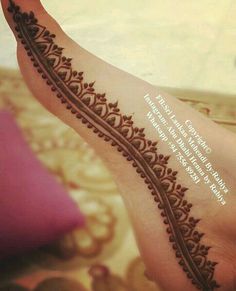 a woman's foot with a henna tattoo on it