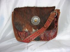 Thank you for shopping my luxurious, handcrafted Western leather handbags, purses, and totes created uniquely from reclaimed cowboy boots. I have been wrangling boots into purses for more than a decade and each new one is my favorite. I hope you enjoy picking out your first one! Each piece tells a story, echoing the rugged beauty and timeless elegance of the Old West. The meticulous craftsmanship ensures that no two bags are alike, offering a one-of-a-kind accessory that stands out in any crowd. Western Style Brown Bags For Rodeo, Western Brown Bags For Rodeo, Brown Rectangular Bag For Rodeo, Rectangular Brown Bag For Rodeo, Country Style Brown Bag For Everyday Use, Western Style Brown Bag With Concho, Brown Leather Bags For Rodeo, Western Style Bags For Festivals, Western Leather Bags For Rodeo