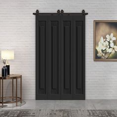 an empty living room with white brick walls and black shutters on the sliding door