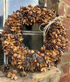 a wreath made out of pine cones and acorns