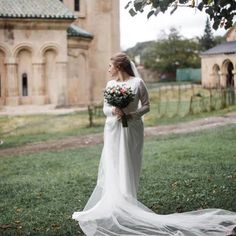 a woman in a wedding dress holding a bouquet