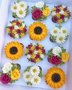 the cupcakes are decorated with sunflowers, roses and other edible flowers