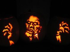 three carved pumpkins with faces on them