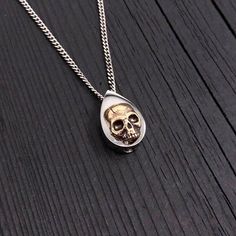 "My cremation urn pendant is made of hypoallergenic stainless steel with a mirror finish. Mounted on the front is a detailed bronze human skull. A discreetly placed screw can be removed from the bottom revealing a small chamber that will contain a small amount of cremated ashes of a departed love one that you wish to eternally keep close to you. After filling, the chamber can be permanently sealed by applying \"lock-tight\" or nail polish to the threads before closing. This little urn necklace m Engraving Fonts, Urn Pendant, Cremation Ashes, Urn Necklaces, Human Skull, Cremation Urns, Memorial Jewelry, Custom Engraving, Stainless Steel