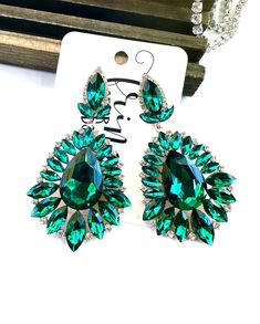 Be sure to check our shop announcements for any current sales or coupon codes!  All discount information will be posted there.  Rhinestone statement earrings Approximate length: 3.5" Stone color: emerald, crystal Metal color: gold Back- Post back Nickel and lead compliant **Variance in computer monitors AND the lack of getting an exact match in person can make the color match tricky  I try to post several pictures at different angles to try to make this as easy as possible.   Feel free to ask an Pageant Earrings, Crystal Statement Earrings, Emerald Crystal, Green Prom, Earrings Emerald, Bling Earrings, Prom Earrings, Stone Dangle Earrings, Crystal Dangle Earrings