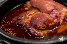 some meat is cooking in a pan on top of the burner and it looks like they have been cooked