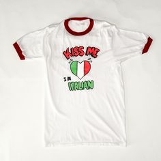 "-vintage late 70's-early 80's Italian white and red ringer tee - 'Kiss Me I'm Italian' graphic Fits like:  XS- S Material:  Cotton  Condition:  Great Length: 28\" / 71 cm Chest: 34\" / 86 cm All measurements are taken with garment lying flat. ALWAYS refer to measurements as vintage sizes run can vary greatly from today's modern sizes. We recommend comparing measurements above with a similar style garment you own for best fit before purchasing.  ▲▲All Garments Have Been Laundered/Steamed or Dry Cleaned and are Ready-To-Wear▲▲ Are you interested in purchasing but don't know how? Here is a link from Etsy guiding you through the process. www.etsy.com/help/article/339 Visit our shop ♥ https://www.etsy.com/shop/fashionrework or www.fashionrework.com" Margelia Kiss Shirt, Cotton Voile Dress, Voile Dress, Chore Coat, Cotton Gifts, Great Lengths, Ringer Tee, Cotton Voile, White And Red