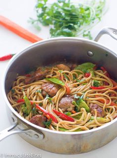 a pan filled with meat and noodles on top of a table