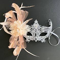 masquerade masks in white. Simplistic for woman with a peach floral- destined to pop out at any event, wedding etc The white women mask is veil decoration with feather and blossoming branches. This masquerade mask is great for any occasion. Wedding Masquerade, White Masquerade Mask, White Masquerade, Masquerade Masks, Masks Masquerade, Peach Wedding, Costume Mask, Masquerade Mask, Pop Out