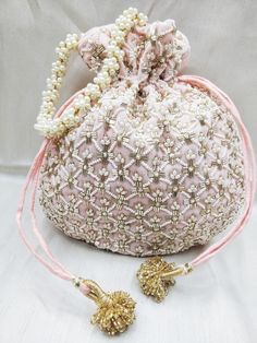 "beautiful golden tubes and pearl beaded embellishment baby pink fabric hand bag for women | bridal party velvet evening bag Package Contents: As per quantity purchased Size: 10\" x 8\" Designed with the heart, this beautiful Potli or batawa bag are eye catchy and made of premium material. Key Features: Embroidery art work This potli is good match with both Indian and western outfits and are superb for wedding and festive parties. This would be best complement to your designer saree, lenhga or a Unique Clutch, Hand Bags For Women, Boho Handbags, Vintage Evening Bags, Everyday Handbag, Diy Bag Designs, Fabric Handbags, Bridal Clutch, Handmade Purses