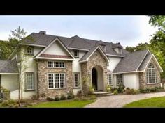 a large house with lots of windows in the front yard