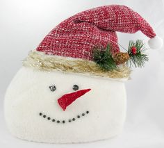 a snowman ornament with a red and white hat on it's head