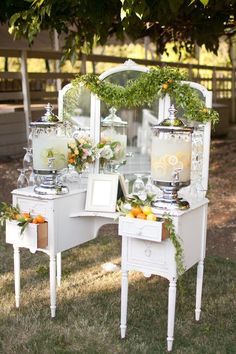 an old vanity is decorated with greenery and candles for the bride's wedding