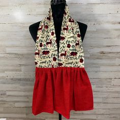 a red and white scarf on top of a mannequin head with an animal pattern