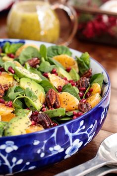 a blue and white bowl filled with spinach salad