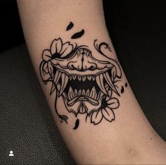 a close up of a person's foot with a tattoo on it and an open mouth