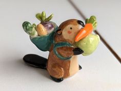 a ceramic figurine of a bear holding vegetables