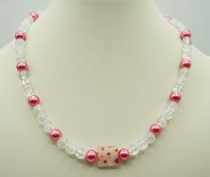 "17\" pink and crackled white beaded necklace/choker Glass beads with Lampworked Glass flower bead accent      Shiny pink glass beads      Crackled clear/white glass beads      Pink and white flowers are on the center bead          The necklace clasp is an \"easy to open and close by yourself\" toggle clasp Ships next business day!" White Beaded Necklaces For Valentine's Day, Valentine's Day White Beaded Necklaces, Handmade White Beaded Necklaces For Valentine's Day, White Adjustable Necklace For Valentine's Day, Handmade White Beaded Necklace For Valentine's Day, Adjustable White Necklace For Valentine's Day, White Beaded Necklace For Valentine's Day Gift, White Beaded Necklace, Pink Choker