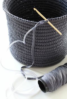 a gray basket with two skewers next to it