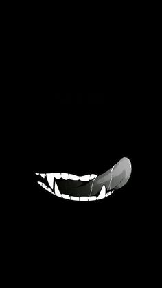 a black and white photo of an animal's teeth in the dark with light coming from its mouth