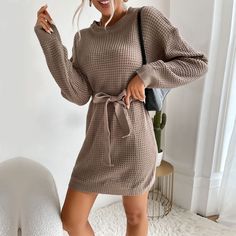 Introducing our Lace-Up Solid Color Long Sleeve Sweater Dress, a chic addition to your autumn/winter wardrobe. Crafted for both style and warmth, this dress features a trendy lace-up detail that adds a touch of sophistication to your look. The long sleeves provide coverage and coziness on chilly days, making it perfect for the colder seasons. Made from high-quality fabric, it ensures durability and comfort for all-day wear. Whether you're heading to work or meeting friends for coffee, this sweater dress is a versatile choice for any occasion. Pair it with tights and boots for a casual yet stylish ensemble, or dress it up with heels for a more elevated look. Embrace the season in style with our Lace-Up Solid Color Long Sleeve Sweater Dress and stay fashionable throughout autumn and winter. Women Sweaters Winter, Waffle Knit Sweater, Tights And Boots, Loose Pullover, Long Sleeve Sweater Dress, Straight Dress, Mini Sweater Dress, Loose Outfit, Daily Dress