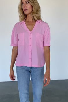 FINAL SALE Perfect casual and comfortable top Soft woven material with great flow Soft French Pink color Collared style with extended placard Button down with matching buttons Patch pockets on front bust Center-back dart detail Dropped shoulder Single-cuffed short sleeve Loose, slightly cropped fit Rounded shirt-tail hem with vents on both sides Trina is 5'6, cup size 32D, size 2 and is wearing size S French Pink, Cuffed Shorts, Button Top, Comfortable Tops, Cup Size, Dart, Effortless Style, Pink Color, Final Sale