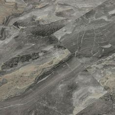 an aerial view of a mountain range with gray and white marble like terrain, as seen from above